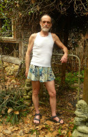 Michael Lowe Wright wearing a tank top and men's skirt with sandals on Wikimedia